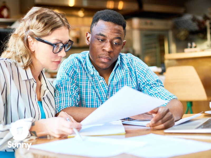 man and woman sit down to negotiate a contract