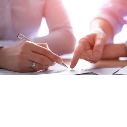 man and woman sit to negotiate an offer